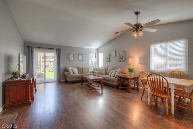 living area with lofted ceiling, ceiling fan, baseboards, and dark wood finished floors