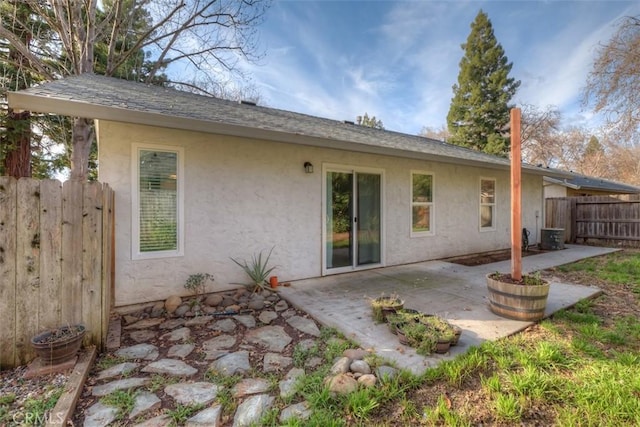 back of property with a patio area, fence, and stucco siding