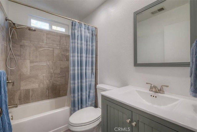 full bathroom featuring visible vents, vanity, toilet, and shower / tub combo with curtain