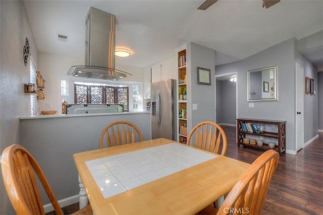 dining space with visible vents, dark wood finished floors, and baseboards