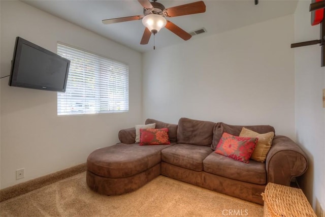 living room with carpet, visible vents, and ceiling fan