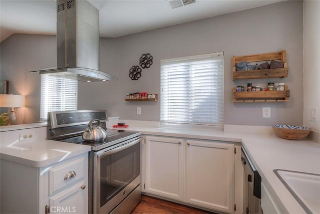 kitchen with visible vents, white cabinets, island exhaust hood, stainless steel appliances, and light countertops