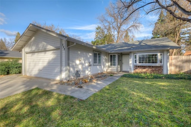 ranch-style home with a garage, fence, a front lawn, and brick siding