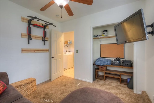 interior space with a closet, washer / clothes dryer, ceiling fan, and baseboards