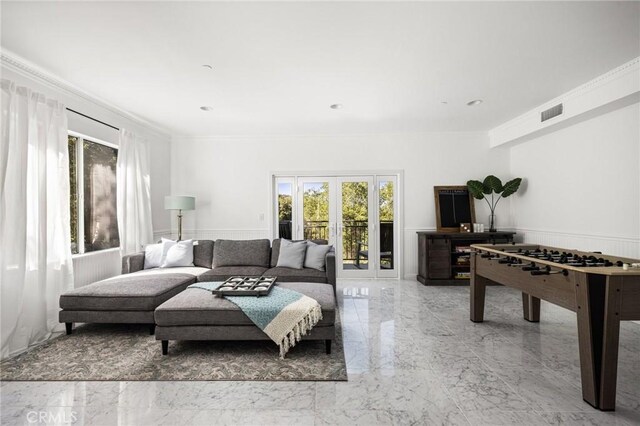 living area with a wainscoted wall, visible vents, marble finish floor, french doors, and crown molding