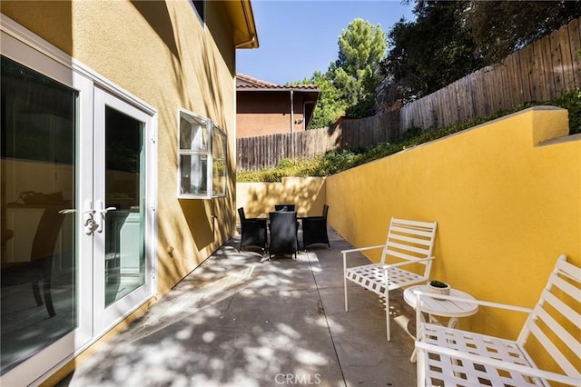 view of patio / terrace with french doors and fence