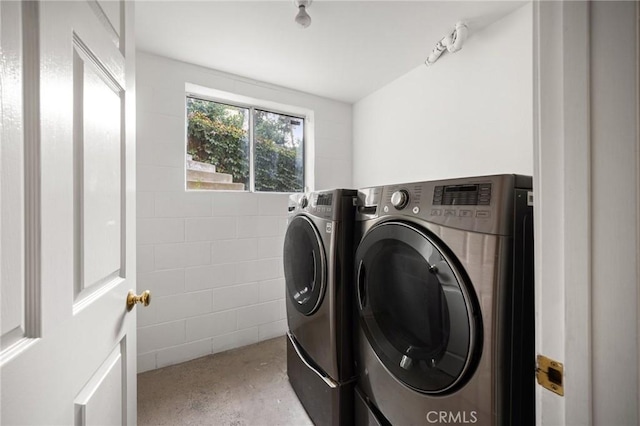 washroom with laundry area and washing machine and clothes dryer