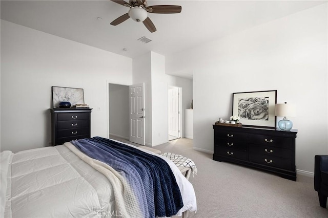 bedroom featuring a ceiling fan, light colored carpet, visible vents, and baseboards