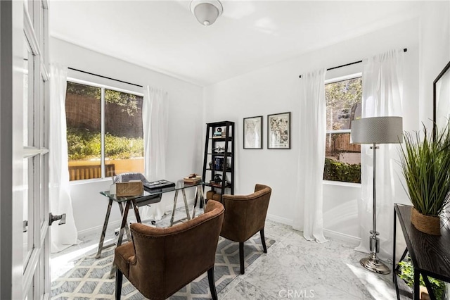 office space with marble finish floor and baseboards