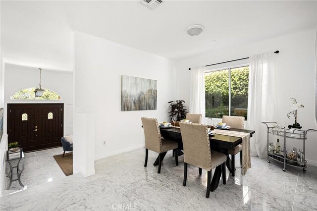 dining room featuring marble finish floor, visible vents, and baseboards