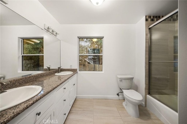 full bathroom with toilet, plenty of natural light, and a sink