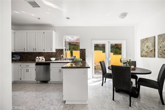 kitchen with visible vents, a peninsula, marble finish floor, french doors, and stainless steel dishwasher