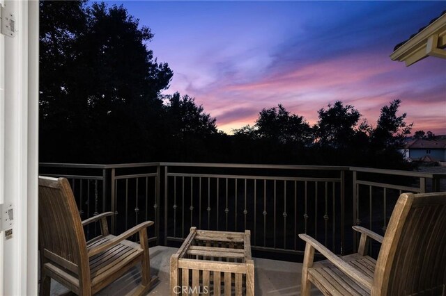 view of balcony at dusk