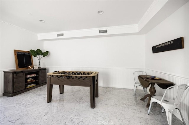 game room with ornamental molding, a wainscoted wall, and visible vents