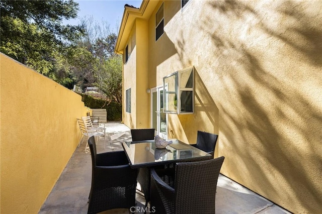 view of patio / terrace featuring outdoor dining area and fence