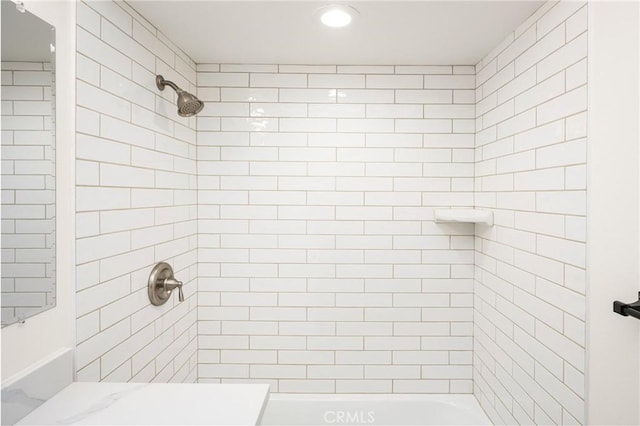 full bathroom with tiled shower