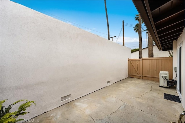 view of patio / terrace with ac unit and fence