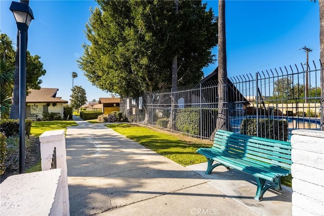 view of property's community featuring fence