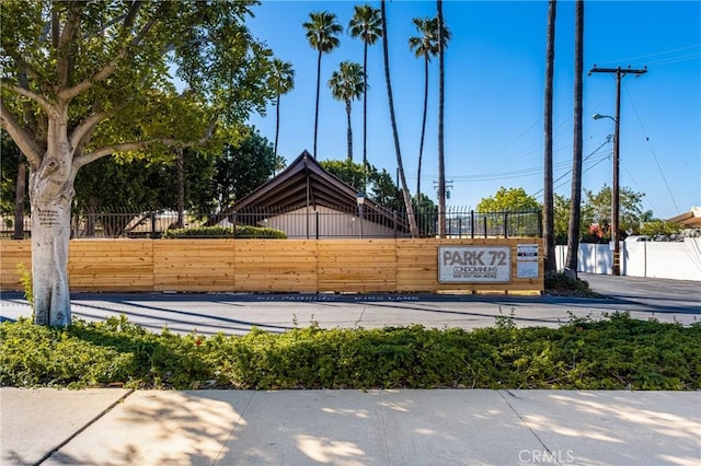 community sign featuring fence