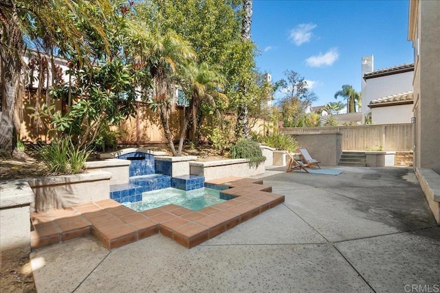 view of swimming pool with a fenced backyard and a patio