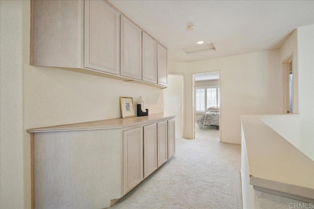 hallway with light colored carpet