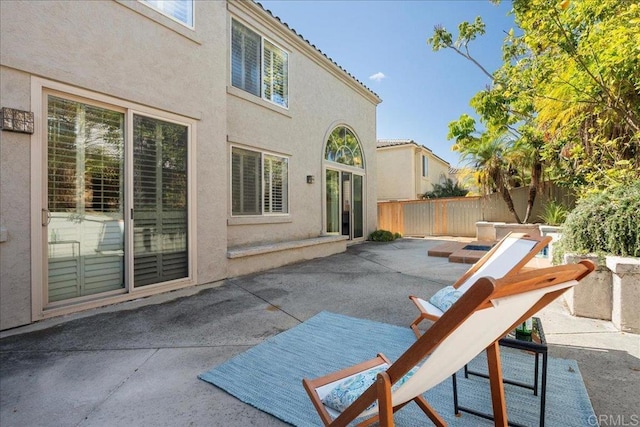 view of patio featuring fence