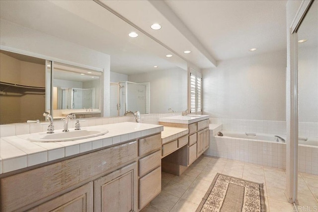 bathroom with a spacious closet, a stall shower, vanity, tile patterned flooring, and a bath