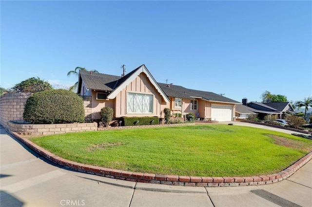 view of front of home featuring a front yard, an attached garage, board and batten siding, and driveway