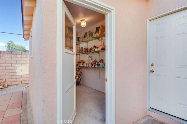 property entrance with stucco siding