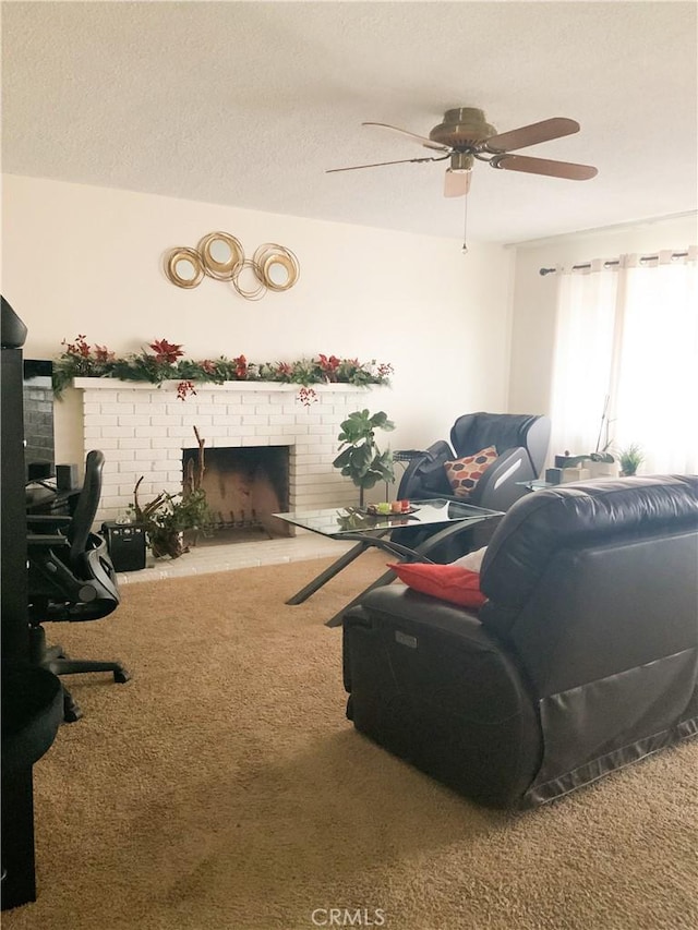 living area featuring carpet floors, a brick fireplace, and a textured ceiling