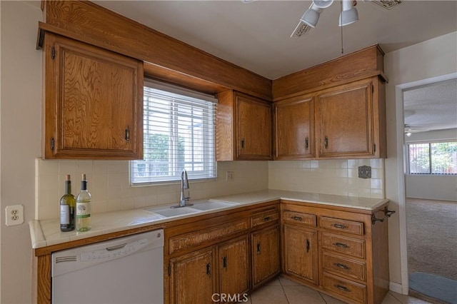 3667 Ada Ct, Riverside, CA 92505 - kitchen with dishwasher, a ceiling fan, brown cabinetry, and tile countertops