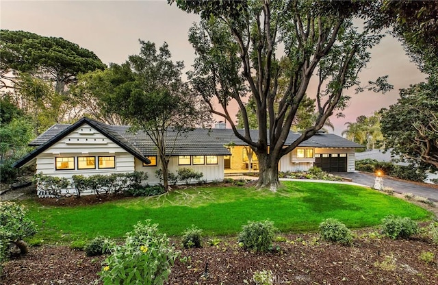 5353 Middlecrest Rd, Rancho Palos Verdes, CA 90275 - view of front of house with asphalt driveway, a lawn, board and batten siding, and an attached garage