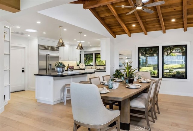 dining room featuring wooden ceiling, light wood-style flooring, visible vents, and beam ceiling