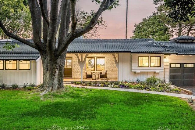 5353 Middlecrest Rd, Rancho Palos Verdes, CA 90275 - view of front facade with an attached garage, board and batten siding, a front lawn, and brick siding