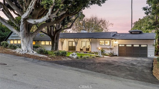 5353 Middlecrest Rd, Rancho Palos Verdes, CA 90275 - view of front facade with asphalt driveway, a chimney, a tile roof, and an attached garage