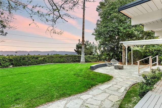 5353 Middlecrest Rd, Rancho Palos Verdes, CA 90275 - yard at dusk with a patio, a fire pit, and a lawn