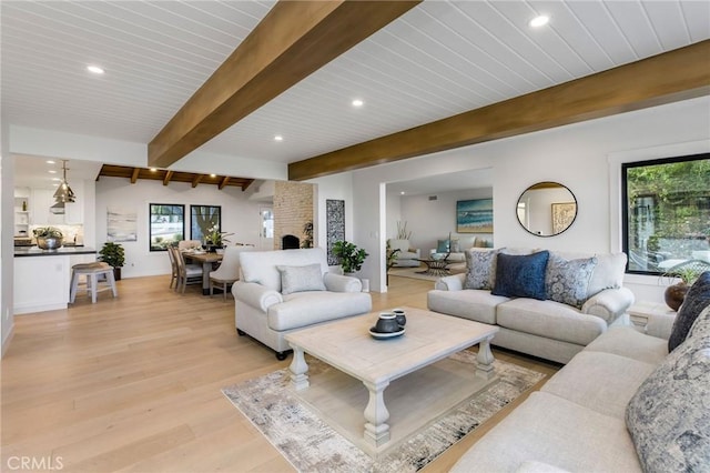 living room featuring beamed ceiling, wooden ceiling, light wood-style flooring, and recessed lighting