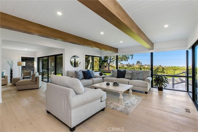 living area featuring light wood-type flooring, visible vents, beamed ceiling, and recessed lighting