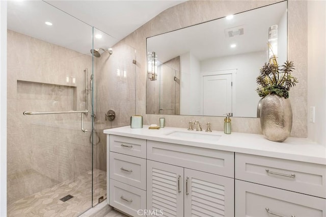 full bath with visible vents, a shower stall, and vanity