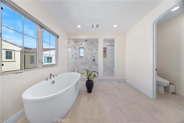 full bath with a freestanding tub, baseboards, and a marble finish shower