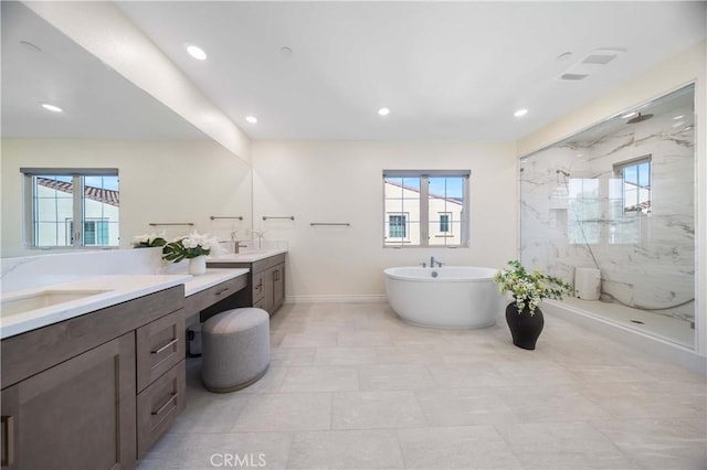 full bathroom featuring plenty of natural light, vanity, and a marble finish shower