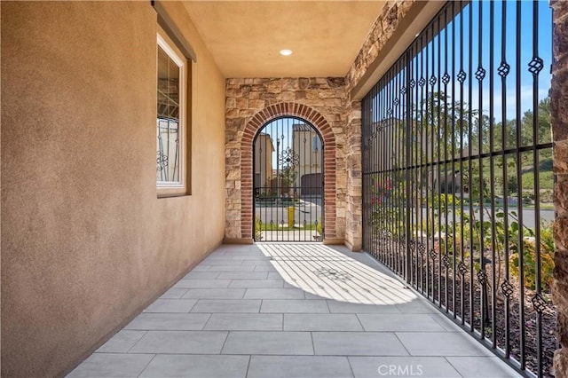 doorway to property with stone siding and stucco siding