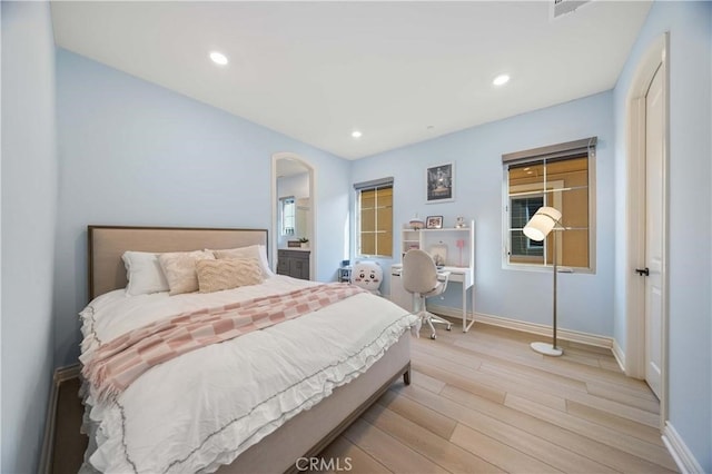 bedroom with baseboards, recessed lighting, and light wood-style floors