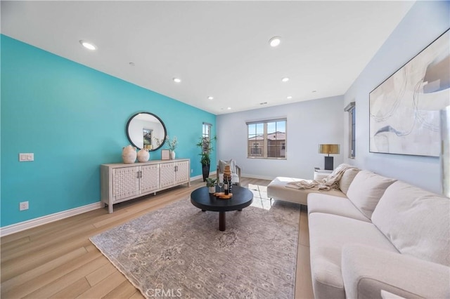 living area featuring baseboards, wood finished floors, and recessed lighting