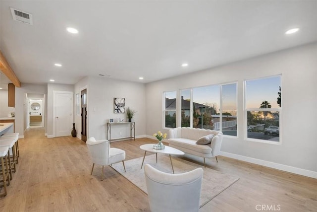 living room featuring recessed lighting, visible vents, and light wood finished floors