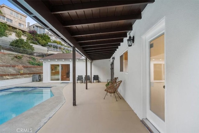 outdoor pool featuring a patio and fence