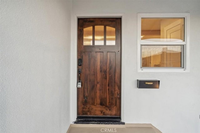 entrance to property with stucco siding