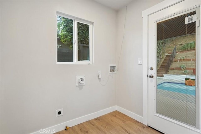 laundry area featuring baseboards, washer hookup, laundry area, light wood-style floors, and hookup for an electric dryer