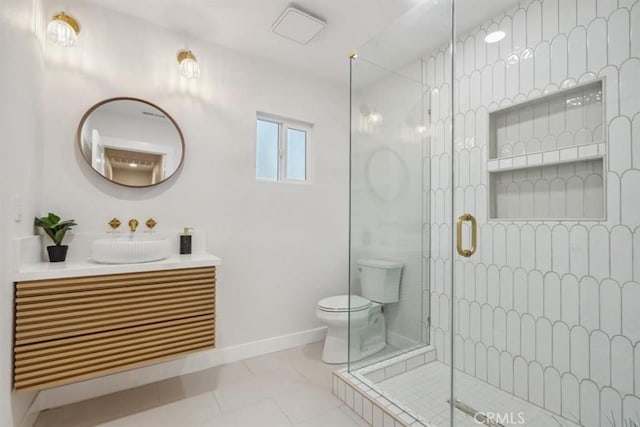 full bathroom featuring a stall shower, toilet, vanity, and baseboards