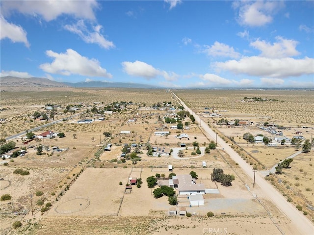 drone / aerial view featuring view of desert, a rural view, and a mountain view